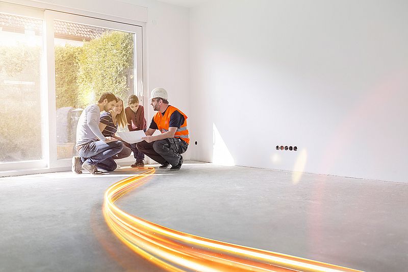 vier personen in hocke betrachten einen plan